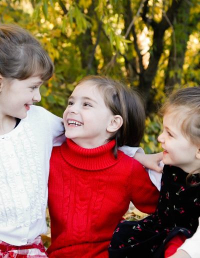 Littleton child photographer family sisters laughter real smiles love in Colorado