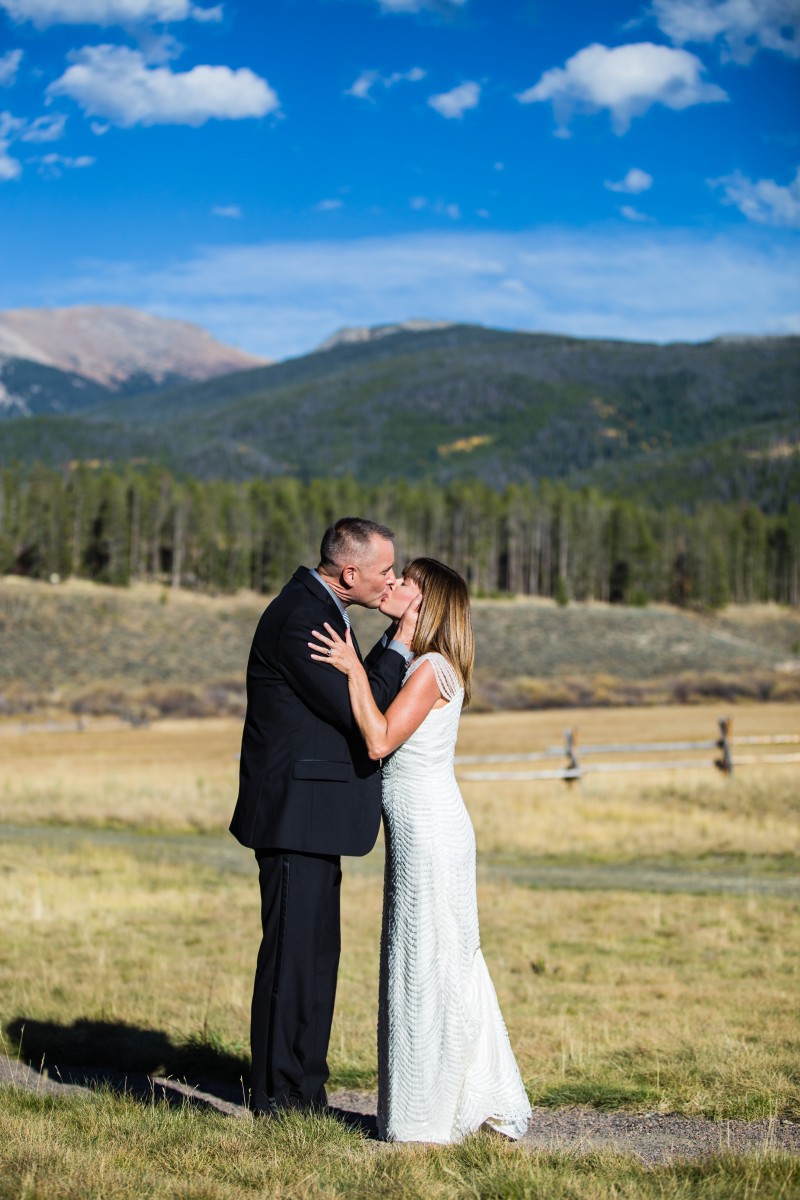 Littleton wedding photographer in Colorado with a mountain view photography bride and groom