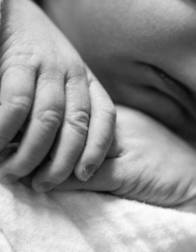 Littleton family photographer newborn baby new macro up close lifestyle in home hands black and white Colorado in home photography