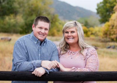 Littleton family photographer couples couple in love husband and wife fall in Colorado married marriage fence Hildebrand Ranch foothills photography
