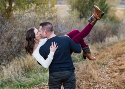 Littleton family photographer couple in love couples fall in Colorado dip kiss foothills sunset