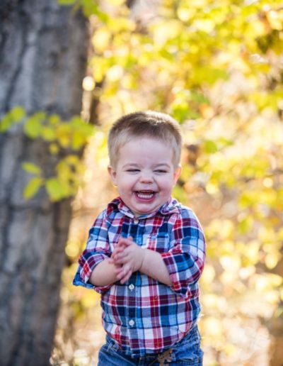 Littleton family photographer little boy toddler happy giggles unposed real outdoor photography Colorado fall yellow leaves trees