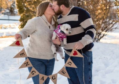 Littleton family photographer engaged couple session engagement esession Highlands Ranch Mansion snow winter in love dog diamond ring banner sunset golden hour light