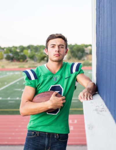 Littleton high school senior portrait photographer Colorado schools photography photo sessions football player at Thunder Ridge Highlands Ranch foothills class of 2020 jersey