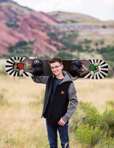 Littleton high school senior portrait photographer Colorado photography senior boy snowboard red rocks rock formations hoodie graduating
