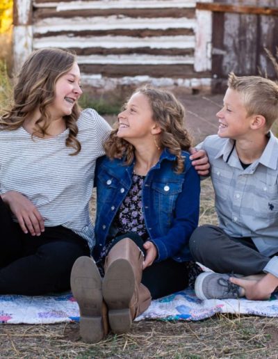 Littleton family photographer in Colorado kid kids children siblings big sister little brother sisters brothers love bond old barn Hildebrand Ranch park fall