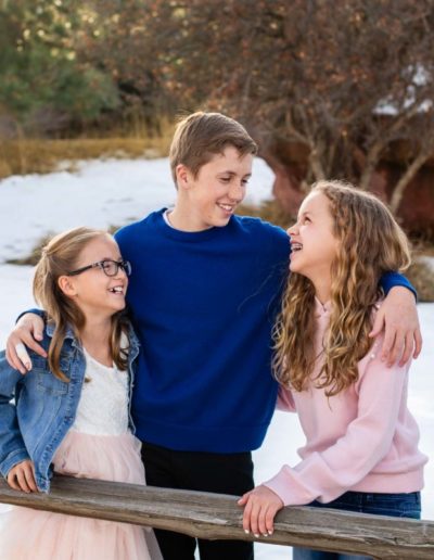 Littleton family photographer siblings kids children big brother little sisters sister girls boys girl boy snow fall red rocks rock formations tween teen high school student middle laughter laughing bond love