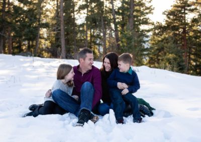 Littleton family photographer in Colorado winter snow mountain view brother sister little big natural light pine trees Mt. Falcon park love bond siblings mother father son daughter mom dad parenthood