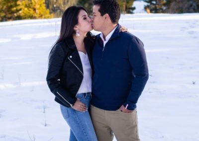 Littleton engaged couple photographer engagement photo session in Colorado family Mt. Falcon in love marriage married kisses kissing kiss pretty diamond ring sunset golden hour snow winter Bolivia