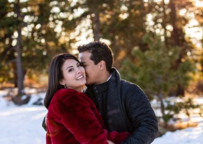 Littleton family photographer in Colorado at Mt. Falcon park in the winter time with snow engagement session engaged future bride and groom husband wife in love