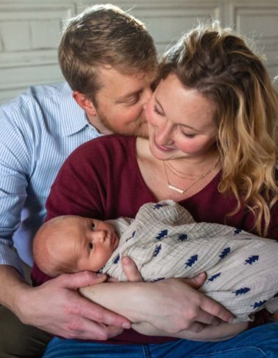 Littleton family photographer newborn new baby photography in home lifestyle photo session boy infant tiny love swaddled mother son father