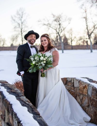 Littleton Colorado wedding photographer bride and groom stone bridge fedora hat snow winter Lakewood Country Club and golf course marriage married