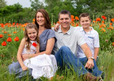 Littleton family photographer in Colorado poppy field wildflowers Morrison private neighborhood red rocks mother father daughter son summer red natural light