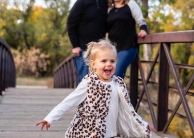 Littleton family photographer Lakewood Stone House bridge happy baby two year old mother father daughter little girl fall photography session outdoor natural light photo