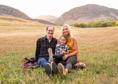 Littleton family photographer Hildebrand Ranch sunset field natural light photography fall mother father son sunset