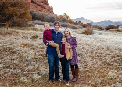 Littleton family photographer in Colorado South Valley Open Space park Ken Caryl red rocks rock formations boys brothers fall photo session cold frost winter mother father sons sunset photography