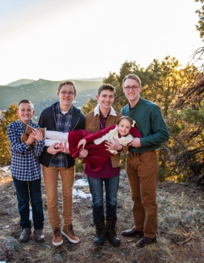 Littleton family photographer in Colorado at Mt. Falcon park snow fall winter kids children big brother little sister mountain view views foothills