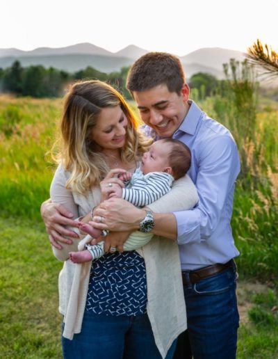 Littleton family photographer extended grandparents grandson mini photo session adult children sunset light dogs visiting Colorado from out of state baby boy parenthood one month old newborn photography outdoors