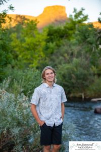 Littleton high school senior photographer teen boy Clear Creek History Park in Golden Colorado ice hockey lacrosse player water river creek sunset foothills view