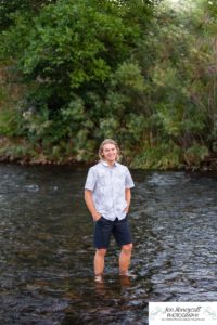 Littleton high school senior photographer teen boy Clear Creek History Park in Golden Colorado ice hockey lacrosse player water river creek sunset foothills view