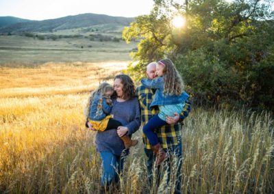 Littleton family photographer South Valley Open Space Park Colorado sunset sun flare foothills kids children love snuggles hugs photography natural light