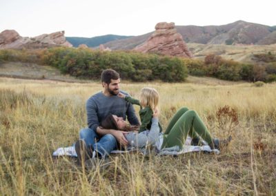 Littleton family photographer South Valley Open Space park Ken Caryl Colorado red rocks daughter little girl mother father guided pose snuggles sunset photography playful real moments
